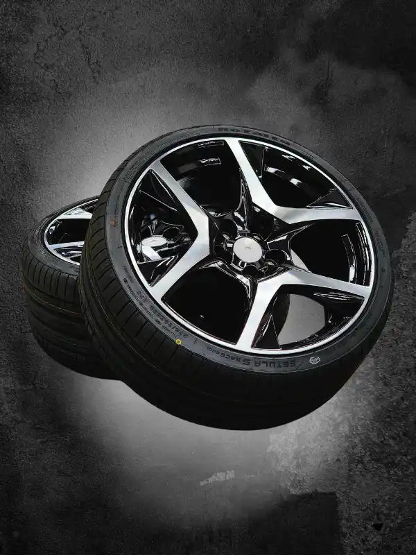 Black and chrome five-spoke alloy wheel with a mounted tire.