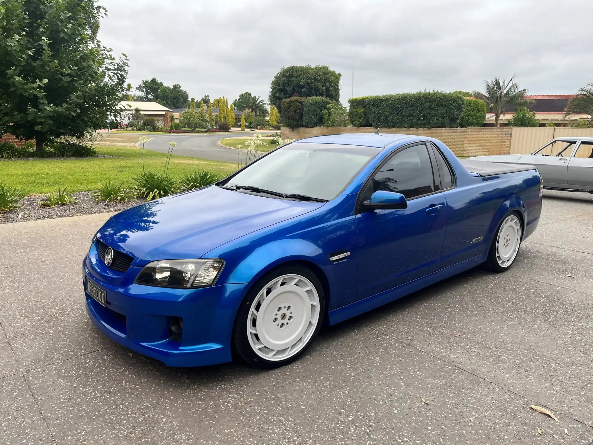 Bright blue Holden Ute with white wheels and lowered suspension.