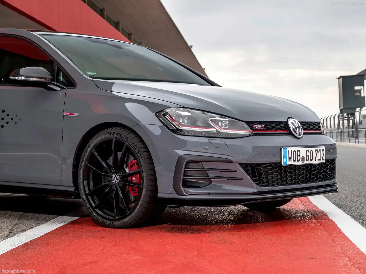 Grey Volkswagen Golf GTI with black wheels and red brake calipers.