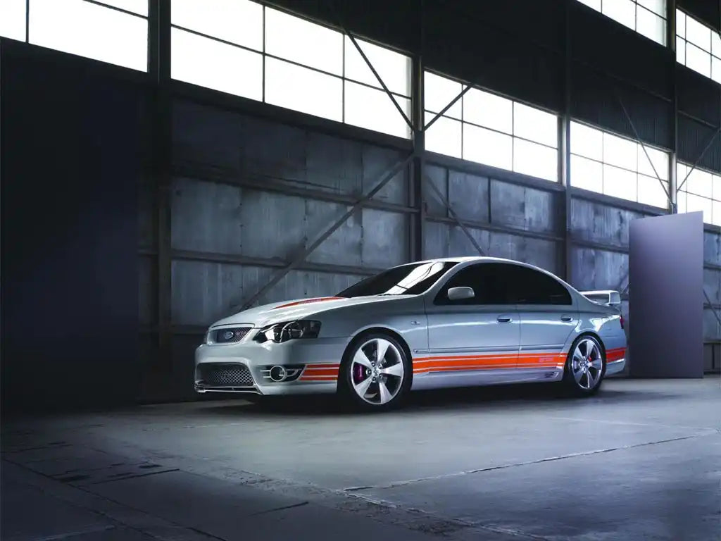 Silver Ford Falcon sedan with orange side stripes and custom wheels.