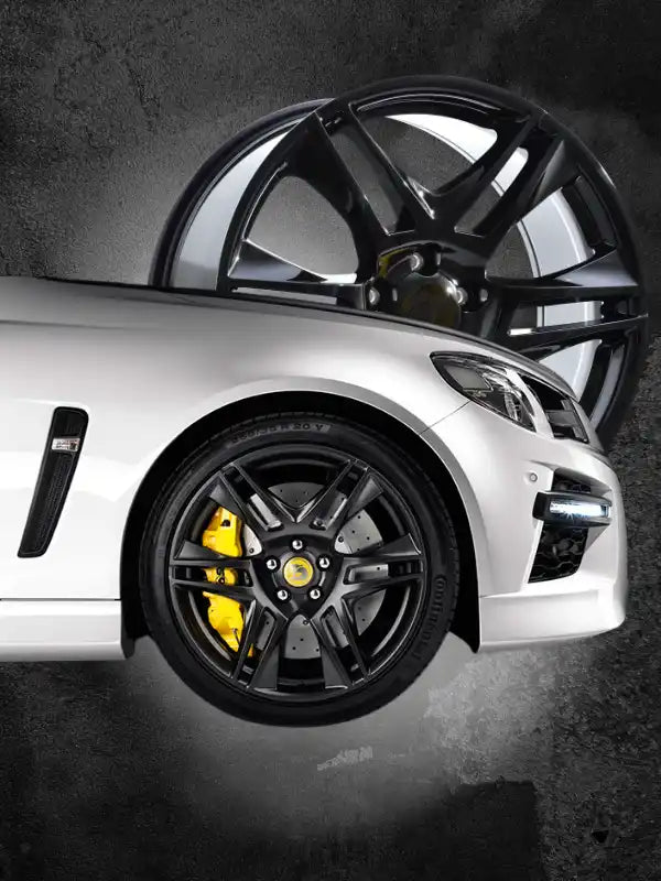 Sleek silver sports car with black alloy wheels and yellow brake calipers.