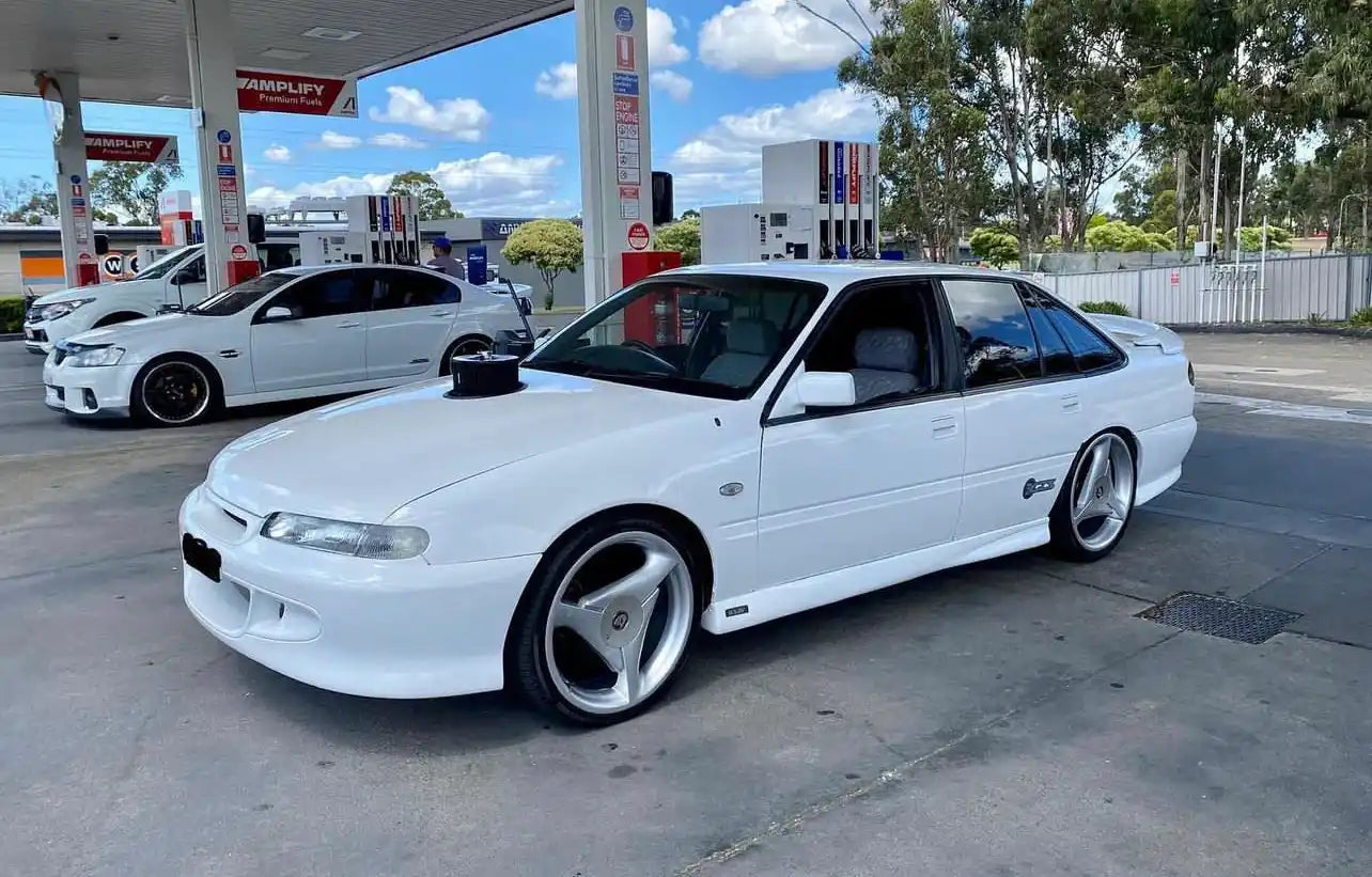 White Holden VS Commodore sedan with aftermarket wheels.